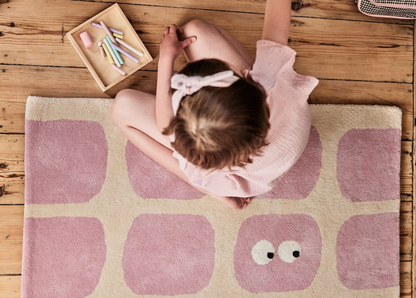 Roze kindervloerkleed met oogpatroon